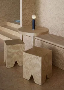 Warm and inviting interior design featuring wooden elements, a table, bench, and stairs, with a lamp on a wooden block