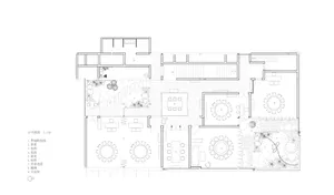 2D floor plan of a hotel with various rooms, including a dining area, kitchen, and seating areas, featuring a mix of styles and well-lit with natural light