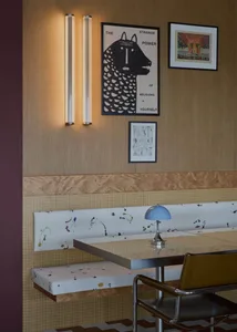 A modern dining area with a glass table surrounded by chairs in a restaurant setting, creating a stylish and contemporary atmosphere