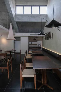 A modern restaurant dining area with multiple tables and chairs, creating a comfortable atmosphere for guests, with a focus on comfort and convenience