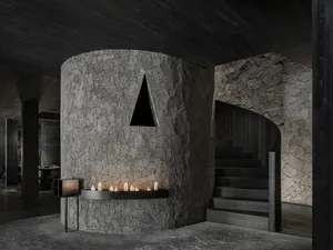 A modern staircase with two sets of steps leading to a stone wall, with a minimalist design and wooden stairs