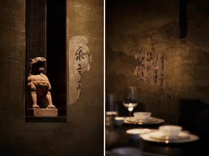 A restaurant and temple scene with wine glasses, cups, and a lion statue, set against a cultural backdrop