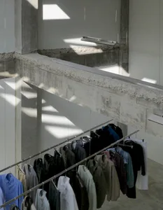 A well-organized wardrobe area with clothes in various sizes and colors hung on racks throughout the space