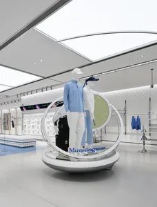 A modern retail space with two mannequins on display, surrounded by a clean and organized environment with a circular display area