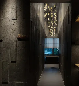 A clean and well-maintained commercial hallway with a row of lights and potted plants