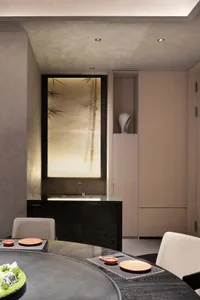 Modern bathroom with a sink area, wooden cabinet, glass door, and two chairs, in a minimalist and contemporary style