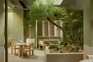 A spacious dining area with multiple tables and chairs, creating an inviting and comfortable atmosphere with various seating options