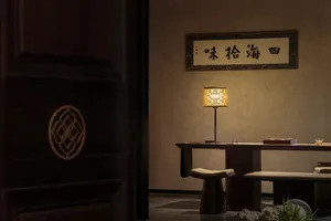 Cozy Asian-style living area with a wooden dining table and modern chairs, surrounded by warm and inviting ambiance