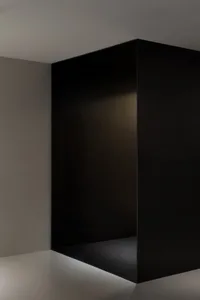 Empty modern hallway with black walls, a calm and quiet atmosphere, and a sense of anticipation