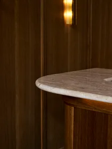 A wooden kitchen countertop with a marble finish, featuring a warm and elegant appearance due to the wood grain