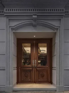 A welcoming restaurant entrance with a wooden door, people inside, and an inviting atmosphere