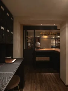 Cozy bakery interior with a counter, dining table, and comfortable seating, featuring a mix of rustic furniture and decorative items