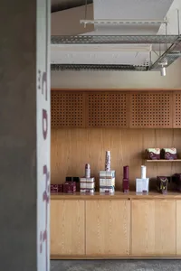 A store display featuring bottles, cups, and boxes on a wooden counter, creating a warm and inviting atmosphere