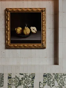 A warm and inviting still life painting of a fruit bowl on a table, featuring three apples arranged in a row
