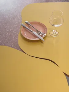 A formal dining table set with wine glasses, a fork, knife, and a bowl, creating an inviting atmosphere for a meal