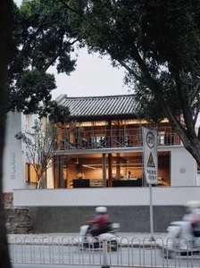 Modern Asian restaurant with a boat-shaped roof, wood and metal elements, and a spacious dining area with tables and chairs