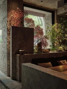 Cozy living space with a dining table surrounded by chairs, two couches, and potted plants