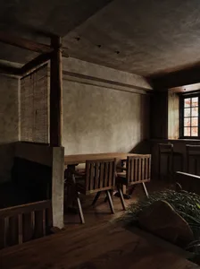 Dining area with wooden floors and walls, a large dining table, and several chairs, creating a warm and inviting atmosphere