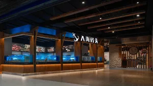 An aquarium store with a wooden design, featuring a large display of fish in tanks, creating a relaxing and enjoyable atmosphere