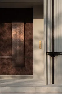 A traditional interior doorway with a brown wooden frame and gold knob, leading to another room within the house