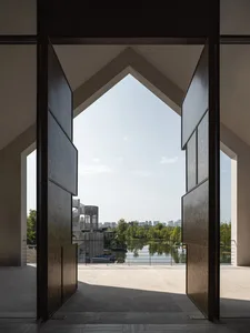 Architectural rendering of a building interior with a wooden door, boats, and natural light