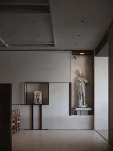 A calm art gallery space with a statue of a woman surrounded by paintings and chairs for visitors to sit and admire the artwork