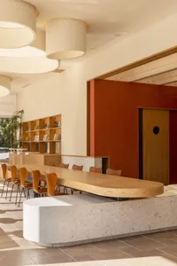 A cozy restaurant interior with wooden tables and chairs, inviting atmosphere, and comfortable seating for guests
