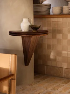 A cozy home interior with a wooden table, vase, and decorative bowls, set in a warm and inviting atmosphere