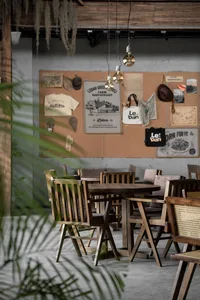 Cozy restaurant interior with wooden tables and chairs, warm atmosphere, and rustic brown wood elements