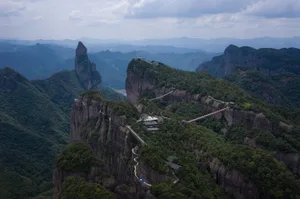 Aerial view of a mountainous area with a stone staircase carved into a rock formation, surrounded by mountains and a valley