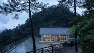 Modern restaurant with a mountain view, featuring a dining area with multiple chairs and a stylish design