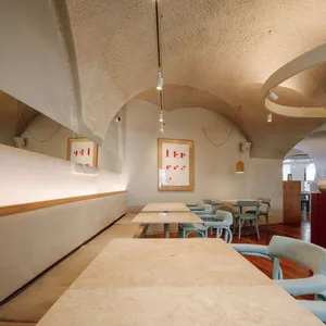 Calm and inviting restaurant interior with stone walls, wooden furniture, and a rustic atmosphere