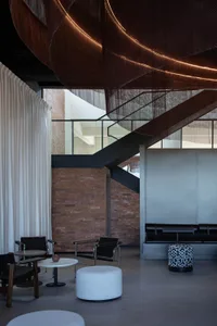 A spacious interior design with a dining table, couch, and multiple chairs in a comfortable and inviting atmosphere