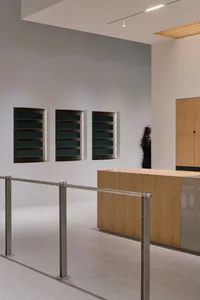 Modern showroom with a wooden countertop and glass doors, featuring various door options