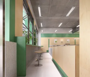 Empty restaurant interior with green walls and flooring, featuring chairs placed throughout the space in a clean and well-organized atmosphere
