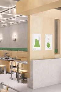 Calm and inviting restaurant with wooden walls, concrete accents, and minimalist dining area