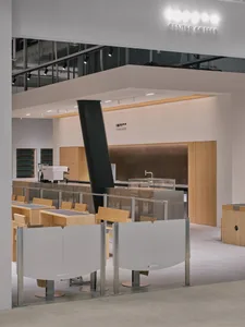 An inviting restaurant interior with wooden tables and chairs, offering ample seating options for guests
