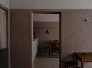 Cozy dining space with stone walls, wooden furniture, and a warm atmosphere