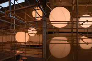 Two scenes of industrial spaces featuring large white spheres in a dimly lit setting with a modern and minimalist design