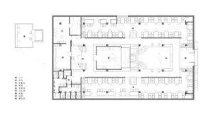 Modern hotel lobby with multiple seating areas, dining tables, chairs, and a well-organized layout