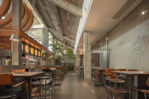 A restaurant dining area with multiple tables and chairs, creating an inviting and comfortable atmosphere for guests