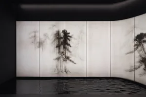 a black and white image of a tree surrounded by water, creating a calm atmosphere