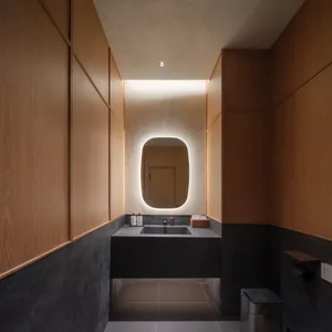 A well-lit bathroom with two sinks and a mirror, featuring a clean and organized atmosphere
