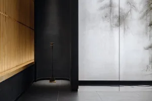 Black walls and grey tiled floor create a calm and inviting modern space with two doors and a contemporary design