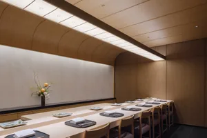 Empty restaurant dining space with wooden tables and chairs, clean and well-organized, warm and inviting atmosphere