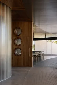Warm and inviting dining space with wooden walls and floors, featuring a table and chairs