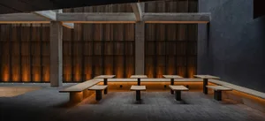 A calm and inviting dining area with wooden benches in rows, suitable for a restaurant or public building