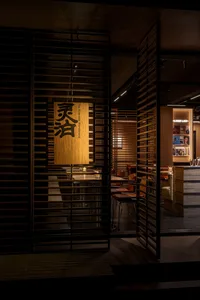 Cozy Asian restaurant with wooden walls and floors, featuring modern-traditional design and warm tones