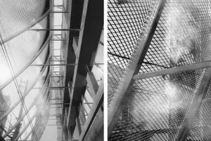 Modern building with a metal facade, balconies on different levels, and a sleek contemporary design