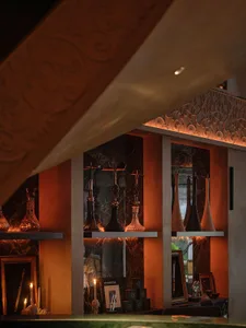 Elegant interior design with a marble wall, wooden ceiling, and tasteful decoration